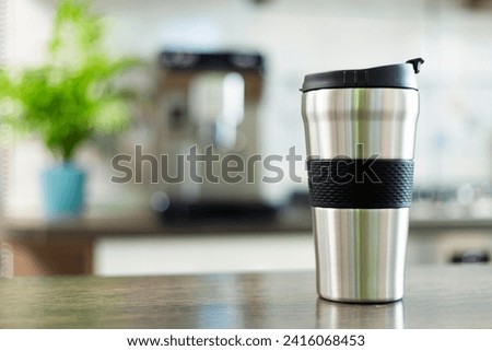 Modern Stainless Steel Travel Mug on Kitchen Counter Royalty-Free Stock Photo #2416068453