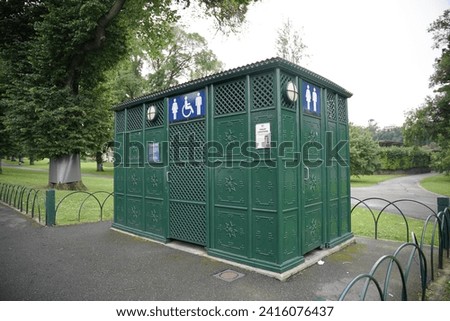 Exterior of modular cabin of modern public toilet in the Melbourne city. Toilet metal building. Front view of modern restroom. Outdoor lavatory with men WC sign Royalty-Free Stock Photo #2416076437
