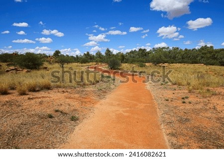 Footpath in the Alice Springs Telegraph Station Historical Reserve in the Red Centre of Australia, connecting Darwin to Adelaide via the Overland Telegraph Line Royalty-Free Stock Photo #2416082621