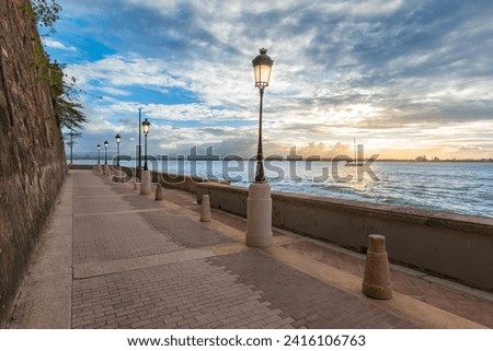 Lanterns along promenade and coastline at dusk, San Juan, Puerto Rico. Royalty-Free Stock Photo #2416106763