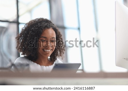 Happy african american businesswoman using digital tablet