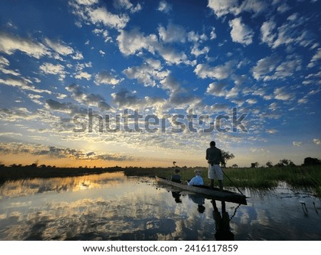 A dug canoe on the waters of the Okavango Delta Royalty-Free Stock Photo #2416117859