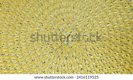 Yellow wicker background close up. Spiral pattern.