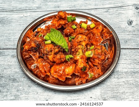 gobi manchurian served in dish isolated on wooden table top view of indian spicy food Royalty-Free Stock Photo #2416124537