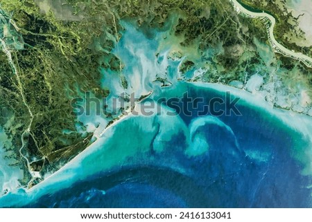 Reshaping Coastal Louisiana. While there are efforts to reinforce its beaches and marshes, some of Barataria Bay is slowly slipping away. Elements of this image furnished by NASA. Royalty-Free Stock Photo #2416133041
