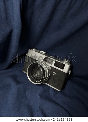 Film camera with a navy cloth background
