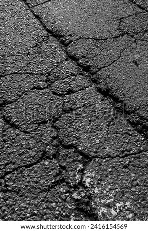 Broken asphalt city street road with cracks