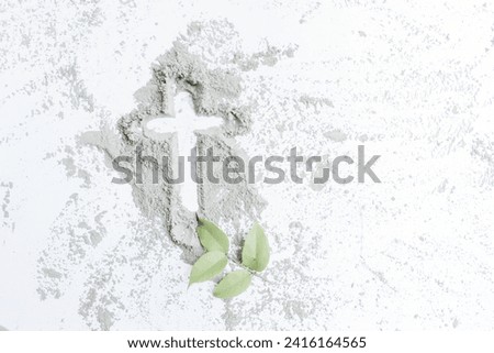 Ash Wednesday. White background with gray crucifix and leaves. Beginning of Lent Royalty-Free Stock Photo #2416164565