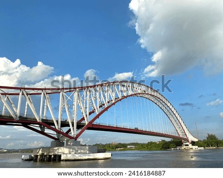 Tenggarong, Kalimantan Timur Indonesia - January 23, 2024: Kota Raja Bridge and the Mahakam River. Royalty-Free Stock Photo #2416184887