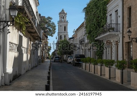 Small street with old crumbling buildings of Spanish conquistador times at Zona Colonial historical Center in Santo Domingo, Dominican Republic. Royalty-Free Stock Photo #2416197945