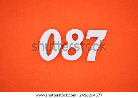Orange felt is the background. The numbers 087 are made from white painted wood.