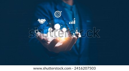 Employing CRM, the businessman manages global customer networks, leveraging technology for data exchanges and development, context of customer service, banking, and strategic business initiatives. Royalty-Free Stock Photo #2416207503