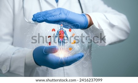 Medical worker holding hologram of a human body with human organs in concept of health. Medical future technology and innovative concept.Elevate healthcare with AI technology services. Royalty-Free Stock Photo #2416237099