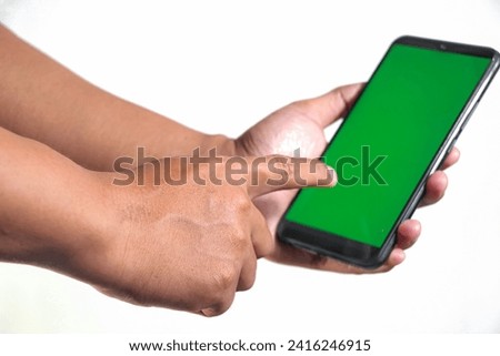 closeup of hands holding smart phones with green screen and showing using device isolated on white background, person sharing media transfer data files, touching monitor, free copy space