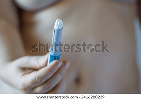 Semaglutide injection pen or cartridge pen for diabetics and weight loss in female hand. Medical equipment for diabetes patients Royalty-Free Stock Photo #2416280239