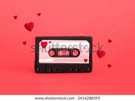 Cute red analog cassette on red background with reds hearts flying around.