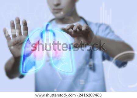 Male doctor using virtual screen with picture of lungs 
