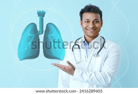 Male Indian doctor using virtual screen with picture of lungs on light blue background