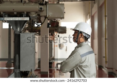 Engineers technicians man wearing professional helmets working in powerhouse or power plant. Royalty-Free Stock Photo #2416292703