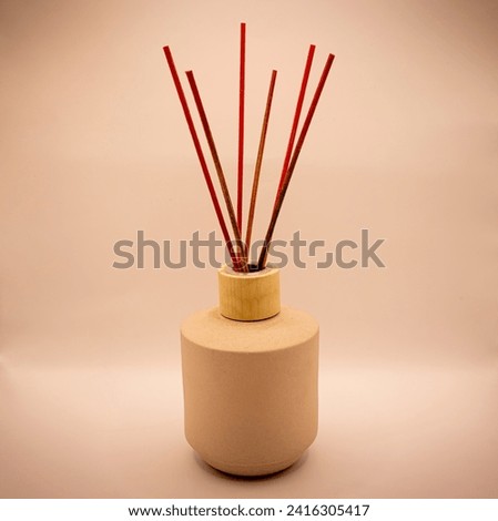 The aroma diffuser with sticks is an elegant way to fragrance your spaces. The sticks absorb the essence and release subtle scents. It serves as both a decorative and functional item, bringing a relax Royalty-Free Stock Photo #2416305417
