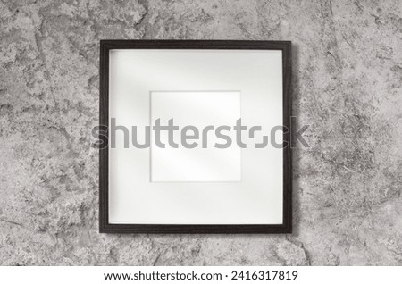 Empty wooden frame with passe-partout and white place for picture on concrete wall with shadows Template with copy space. 