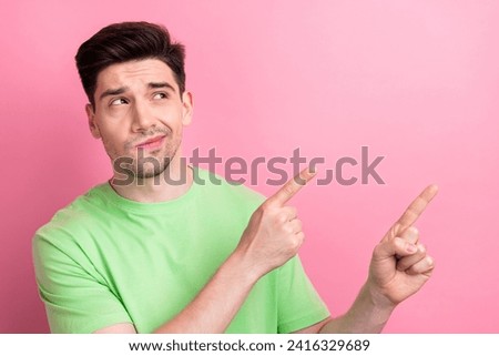Photo of young thoughtful ponder funny guy pointing banner with important information presentation isolated on pink color background