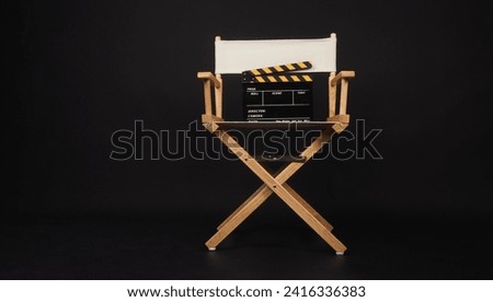 White director chair with clapper board on black background  Royalty-Free Stock Photo #2416336383