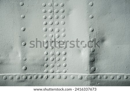 plate metal on board, plates joined with rivets