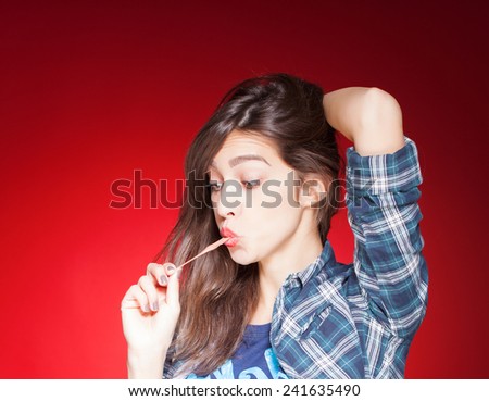 young beautiful girl posing grimacing with chewing gum