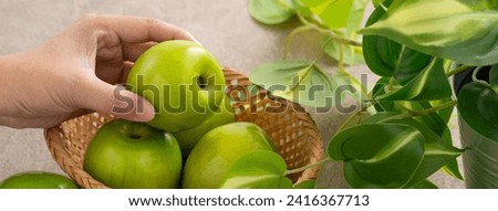 Fresh juicy delicious Taiwanese Milk Indian Jujube fruit in a basket on gray table background. Royalty-Free Stock Photo #2416367713