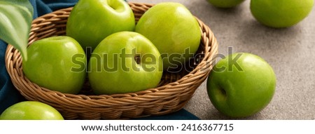 Fresh juicy delicious Taiwanese Milk Indian Jujube fruit in a basket on gray table background. Royalty-Free Stock Photo #2416367715