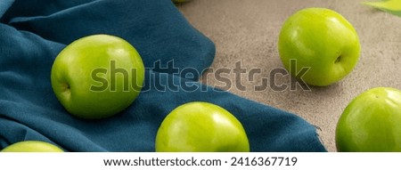 Fresh juicy delicious Taiwanese Milk Indian Jujube fruit in a basket on gray table background. Royalty-Free Stock Photo #2416367719