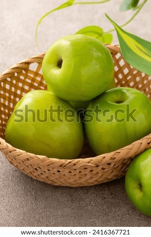 Fresh juicy delicious Taiwanese Milk Indian Jujube fruit in a basket on gray table background. Royalty-Free Stock Photo #2416367721