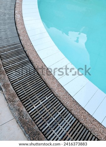 edge of the swimming pool with its blue water