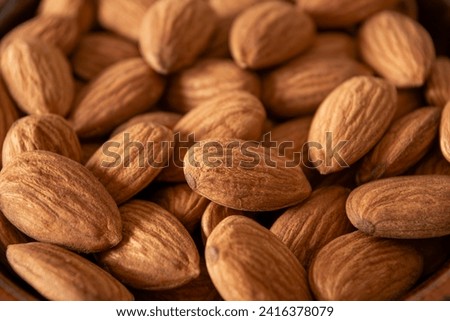 Close view of natural raw almonds with skin Royalty-Free Stock Photo #2416378079