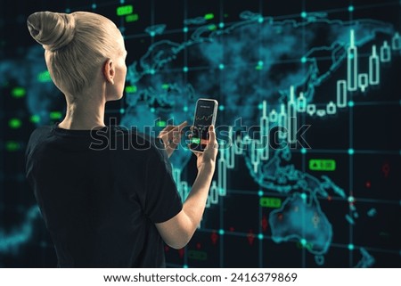 Back view of blonde woman using smartphone with glowing forex chart and map on dark background. Trade, stock and finance concept