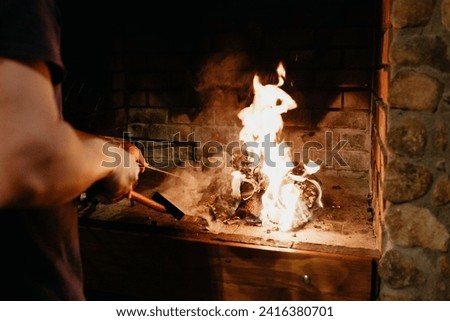 Close up of person making a barbecue fire in fireplace , locally called "braai"