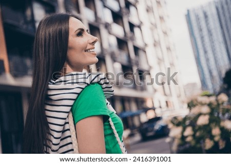 Side profile photo of adorable latin young woman looking side good mood enjoy weekend spending outdoors on residential complex background