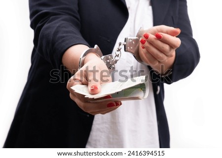 Close-up of corrupted arrested businesswoman corporate entrepreneur in handcuffs offering cash money as bribe isolated on white background