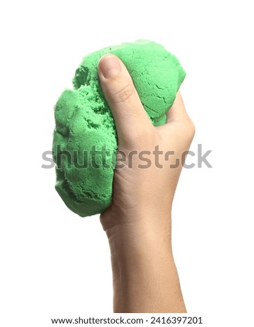 Woman playing with green kinetic sand on white background, closeup Royalty-Free Stock Photo #2416397201