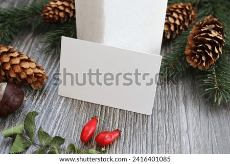 Empty business card mockup with christmas decoration on wooden table background. Mock up for branding identity. Blank template for your design.