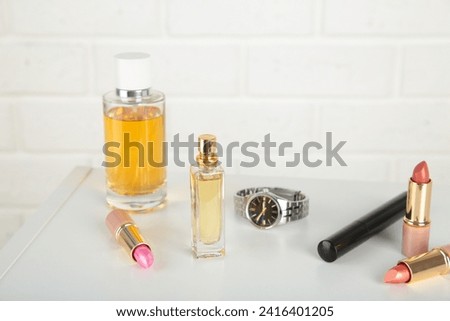 Cosmetic set on light dressing table on light background. Top view