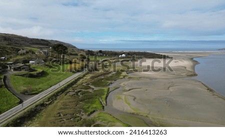 A drone view of the Poppit Sands Beach under a blue cloudy sky in Wales Royalty-Free Stock Photo #2416413263