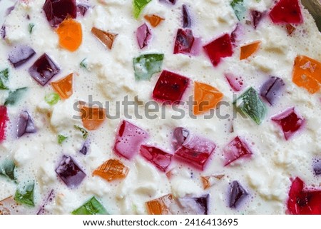 Cake with multi-colored jelly and white cream. Close-up stock photo of dessert in best quality.