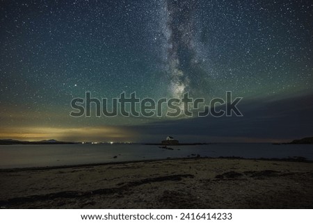 The Milky Way and night sky over St Cwyfans Church at Anglesey, Wales