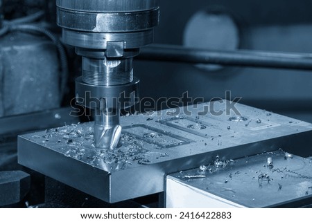 The plunge cutting  process on NC milling machine with flat end mill tools. The metal working concept on the milling machine. Royalty-Free Stock Photo #2416422883