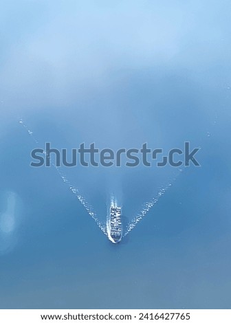 Blurred picture of a cargo ship sailing at sea taken form the window of an airplane