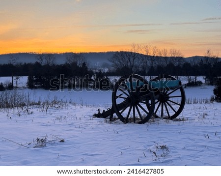 Civil war cannon in an open field on a winter morning Royalty-Free Stock Photo #2416427805