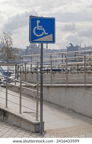 Wheelchair Accessible Switchback Ramp at Street With Sign