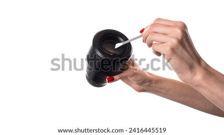 Camera lens isolated. Hand holding camera lens in hands isolated on white background. High quality photo